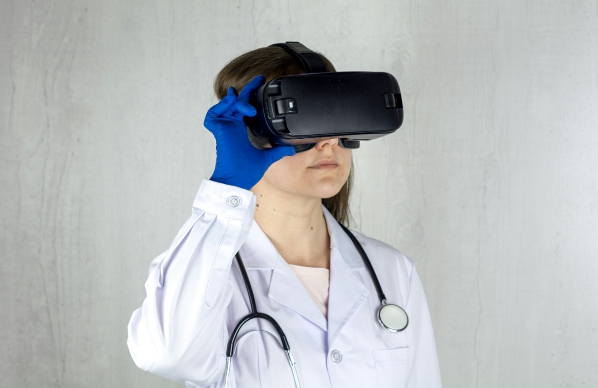 Clinician evaluating a sensor-based virtual reality headset used in physiological data capture